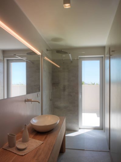View of the secondary bathroom with aluminum-clad French door