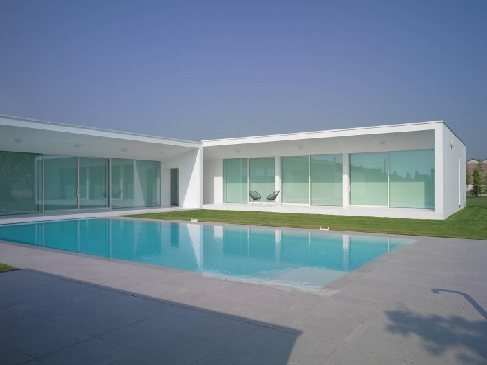 View of the main façade of Villa Verona with lift and slide glass walls and lowered blackout curtains